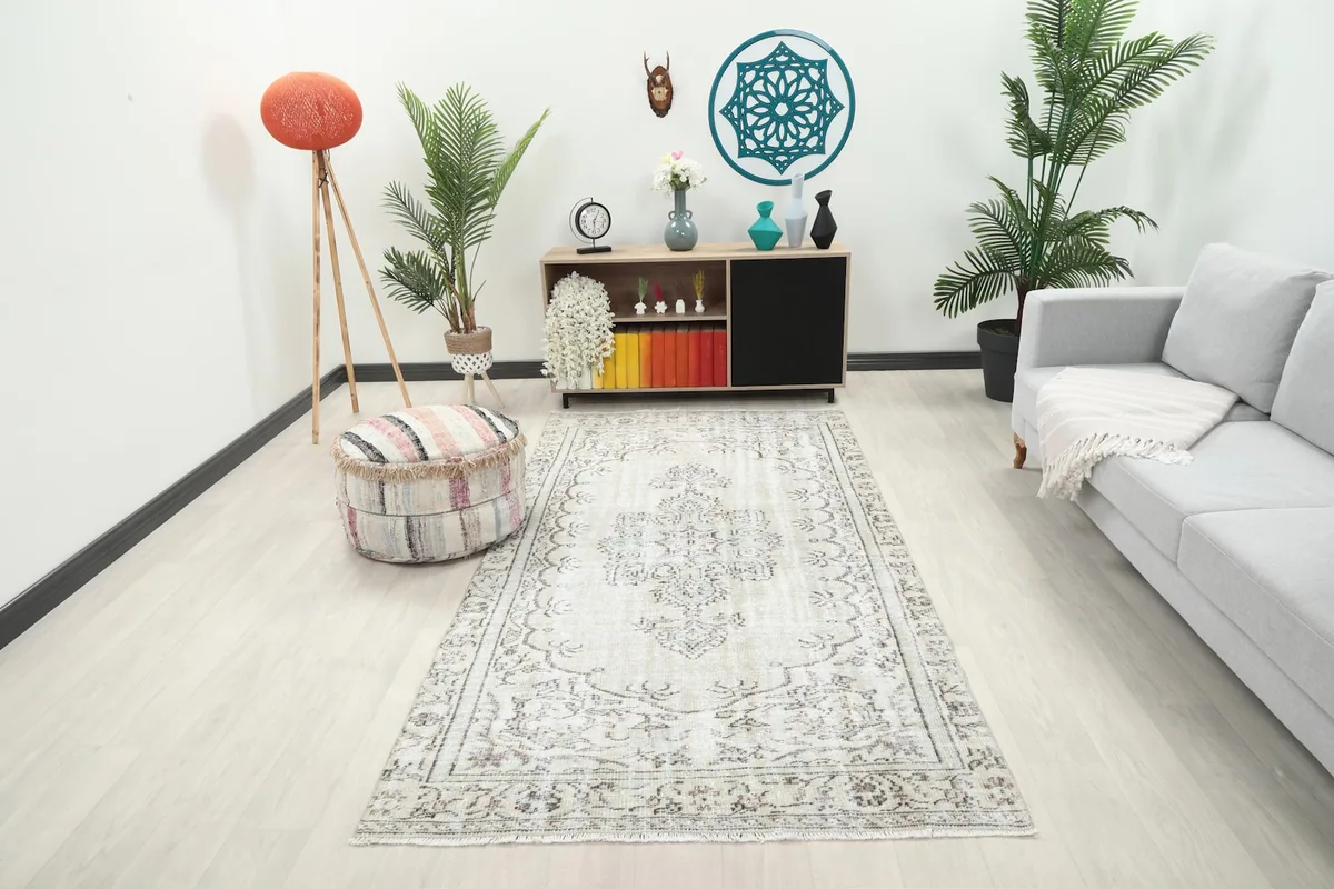 Ivory vintage Anatolian rug in a modern living room setting, full view
