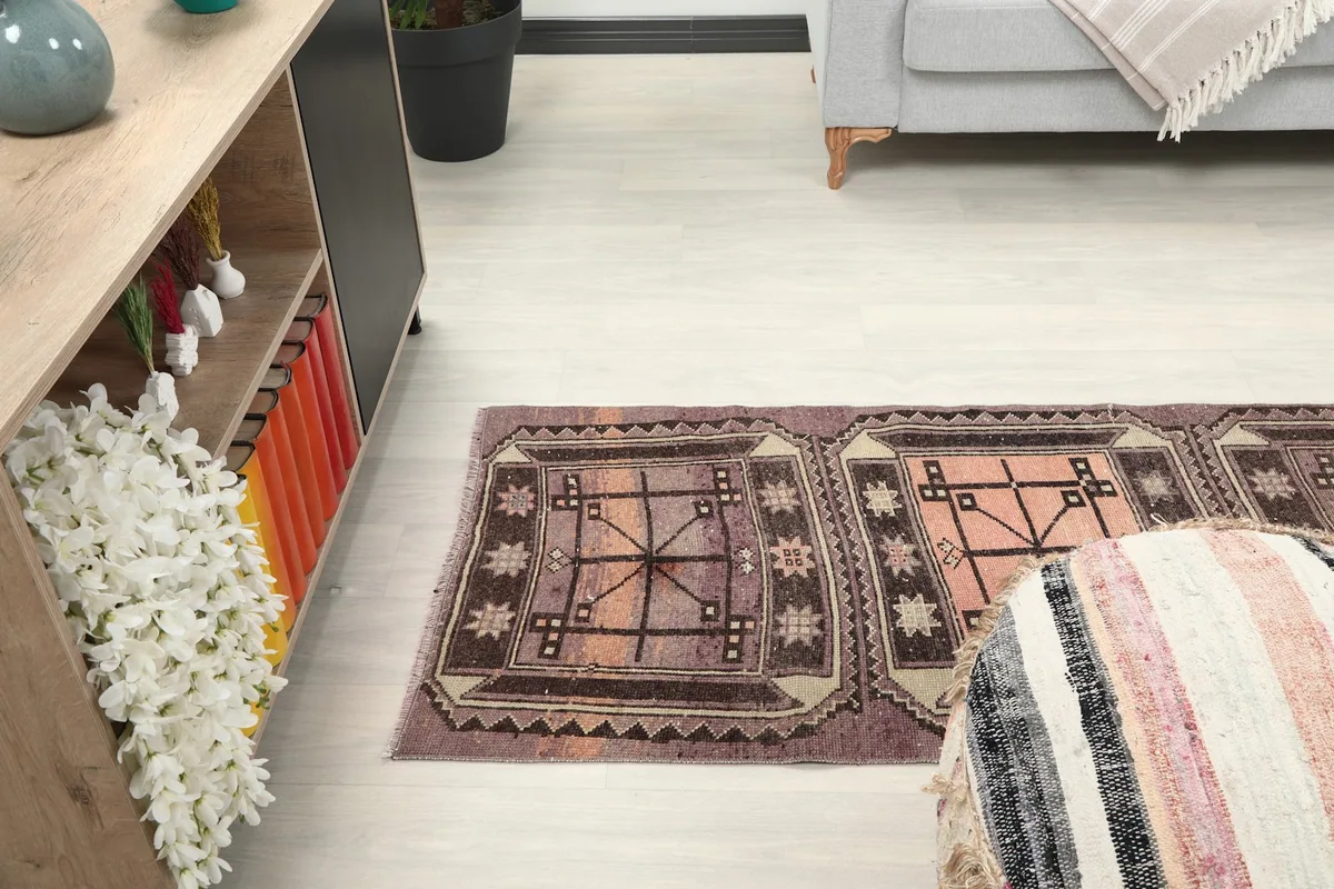 Side view of the runner rug extending down a hallway-like space