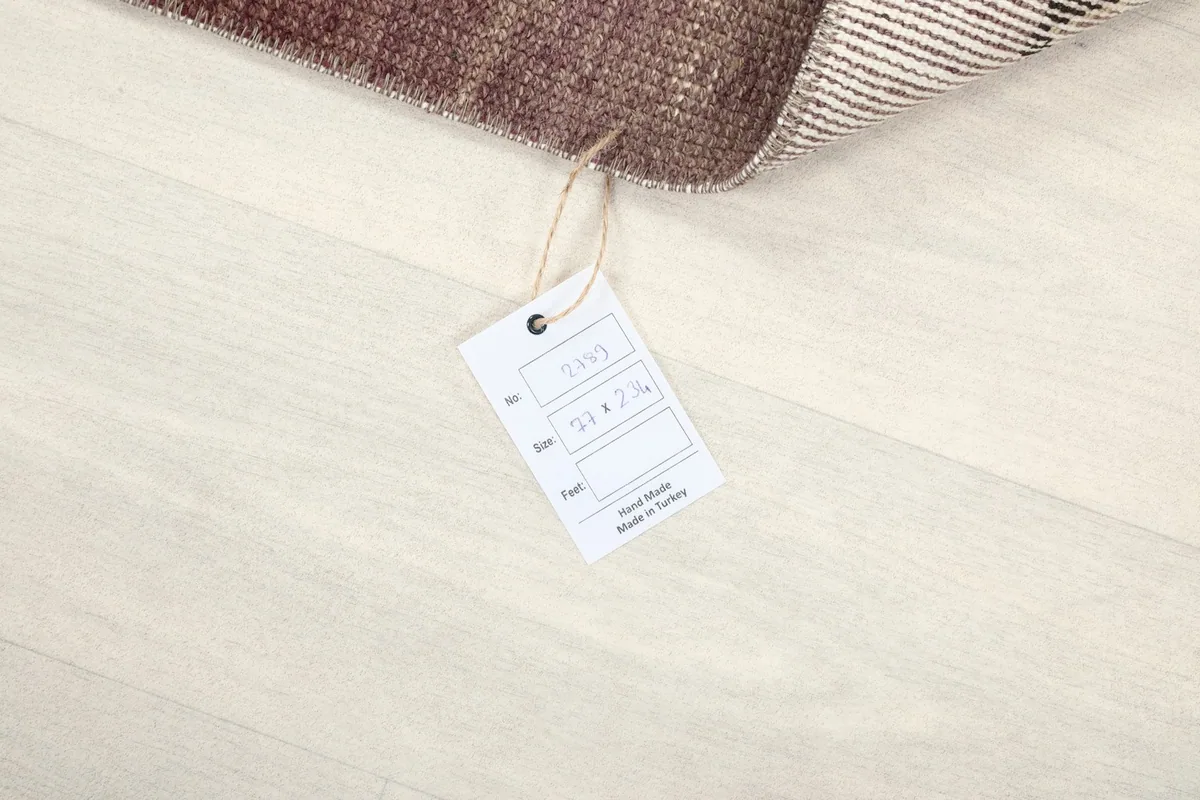 Product tag attached to the rug, displaying information about its origin and material