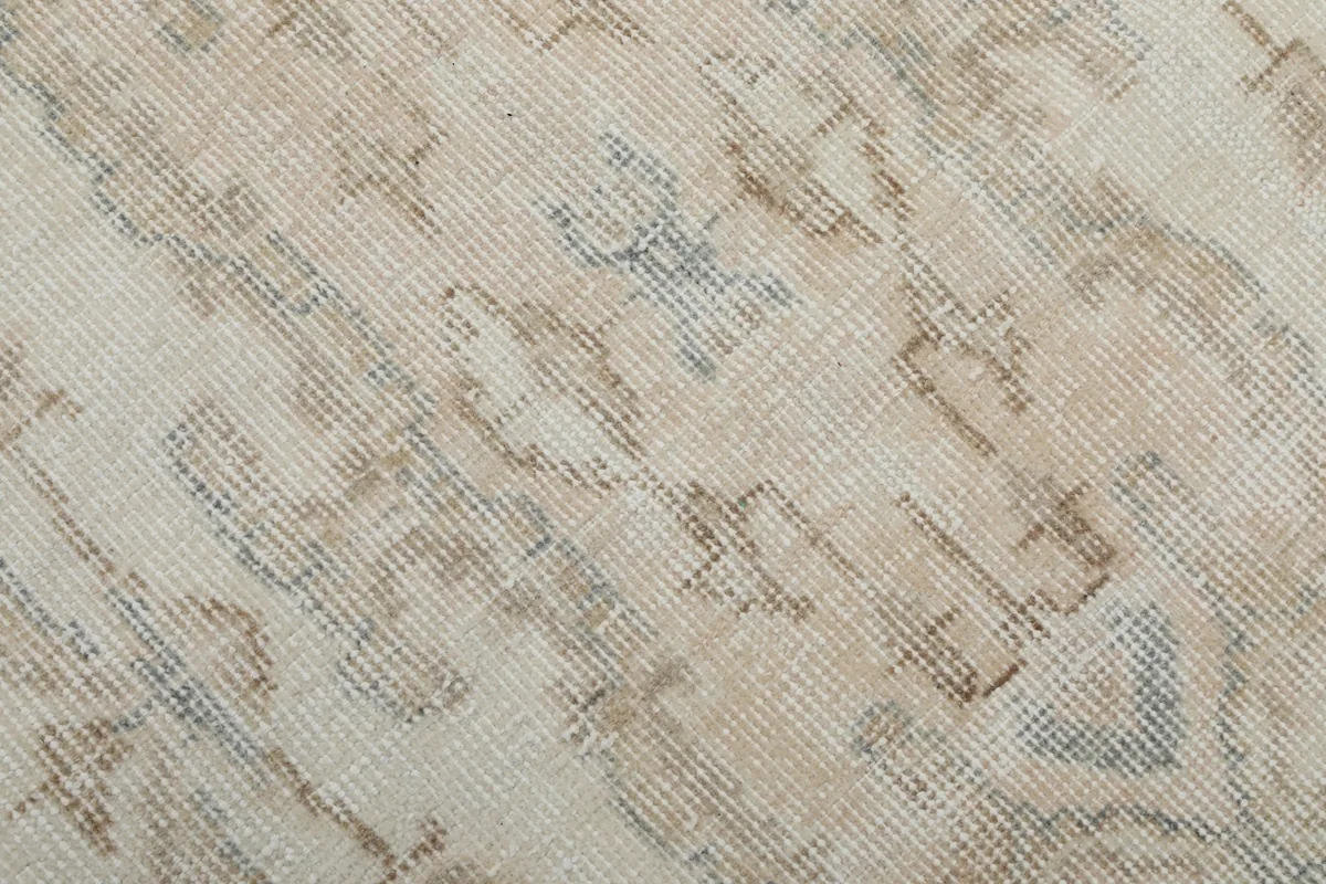 Close-up of the rug's low pile, showing the hand-knotted texture and subtle color variations.