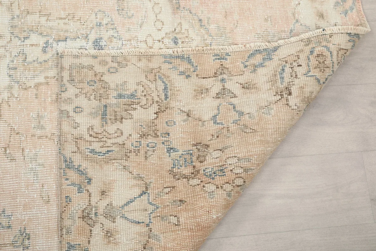 Another view of the rug's underside, showing the tightly woven cotton foundation and visible knotting.