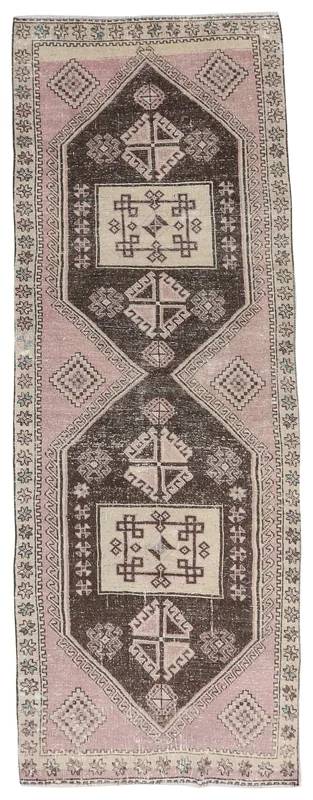 Full overhead view of the 3x10 pink and brown geometric vintage runner rug on a white background.