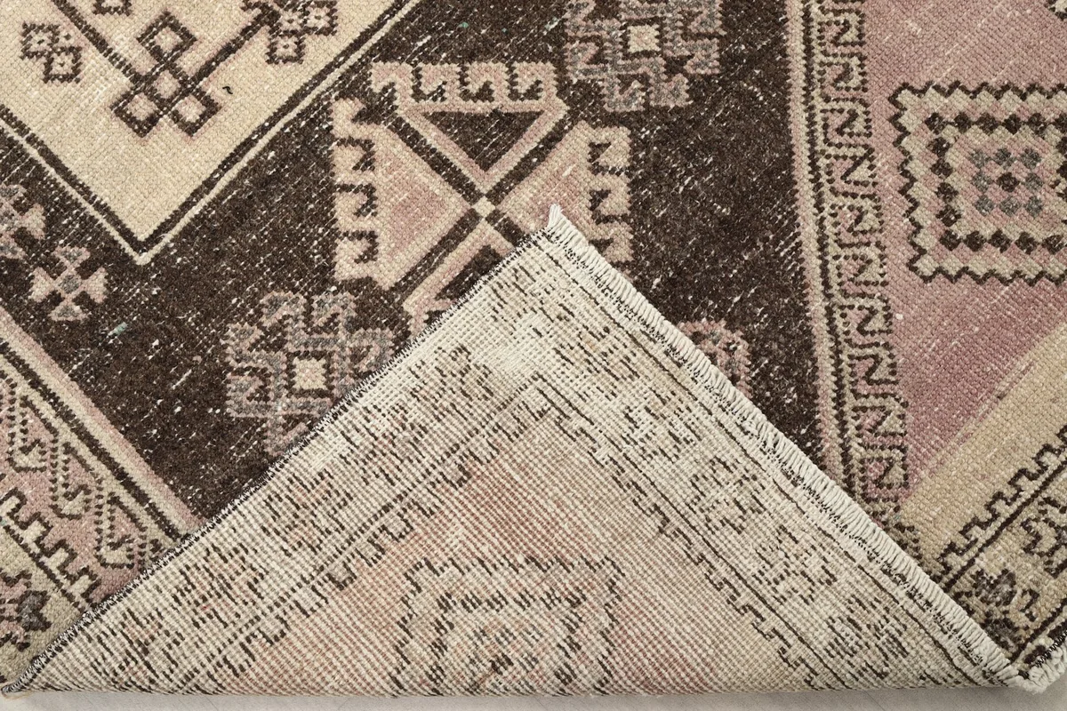 View of the back of the hand-knotted rug, revealing the tight weave and cotton foundation.