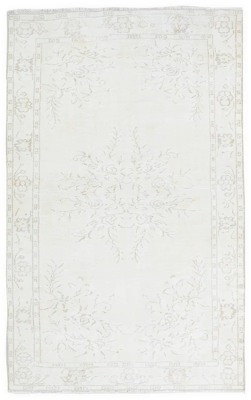 Full top view of the ivory and beige vintage Anatolian area rug with floral motifs