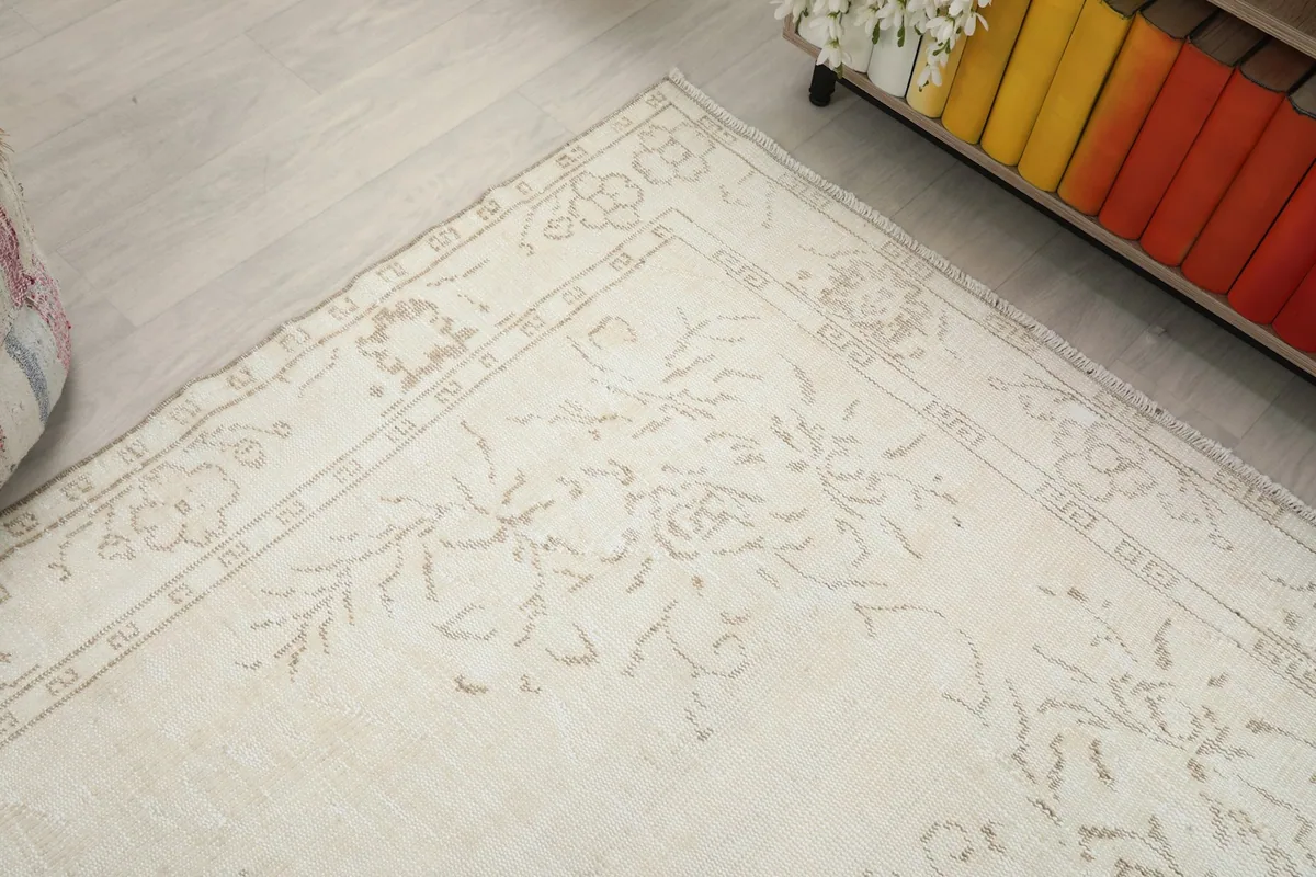 Corner view of the vintage rug, showing the integrity of the border and field