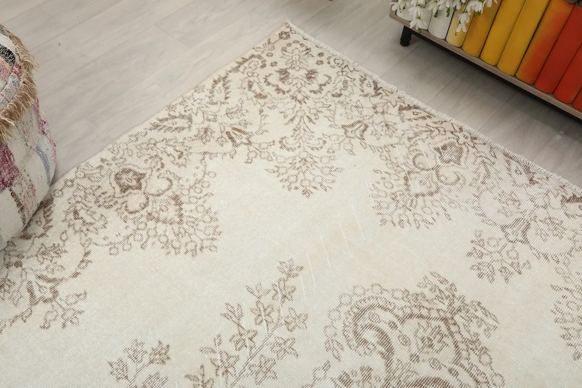 Corner view of the vintage rug, highlighting the intricate floral patterns