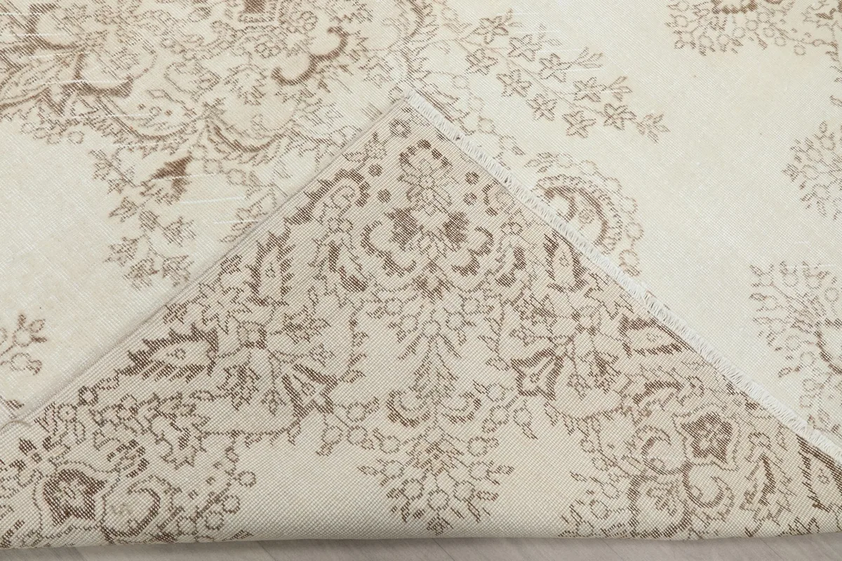 Folded corner showing the reverse side of the hand-knotted wool rug