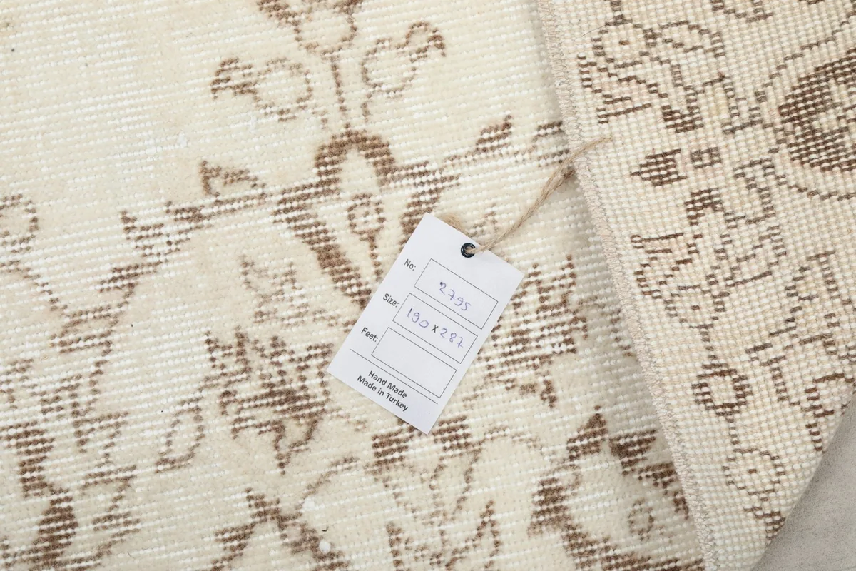Back of the rug with a product tag, revealing the tight knotting
