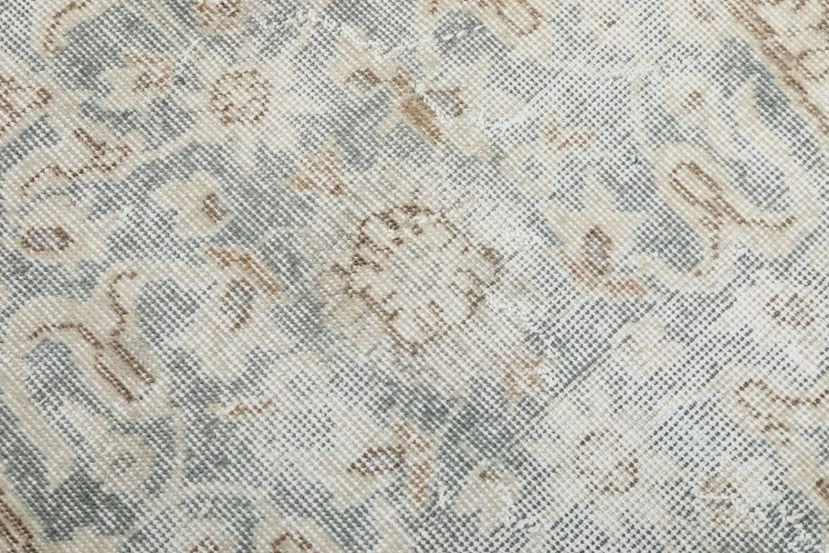 Texture shot of the low wool pile, revealing the hand-knotted construction and gentle wear.