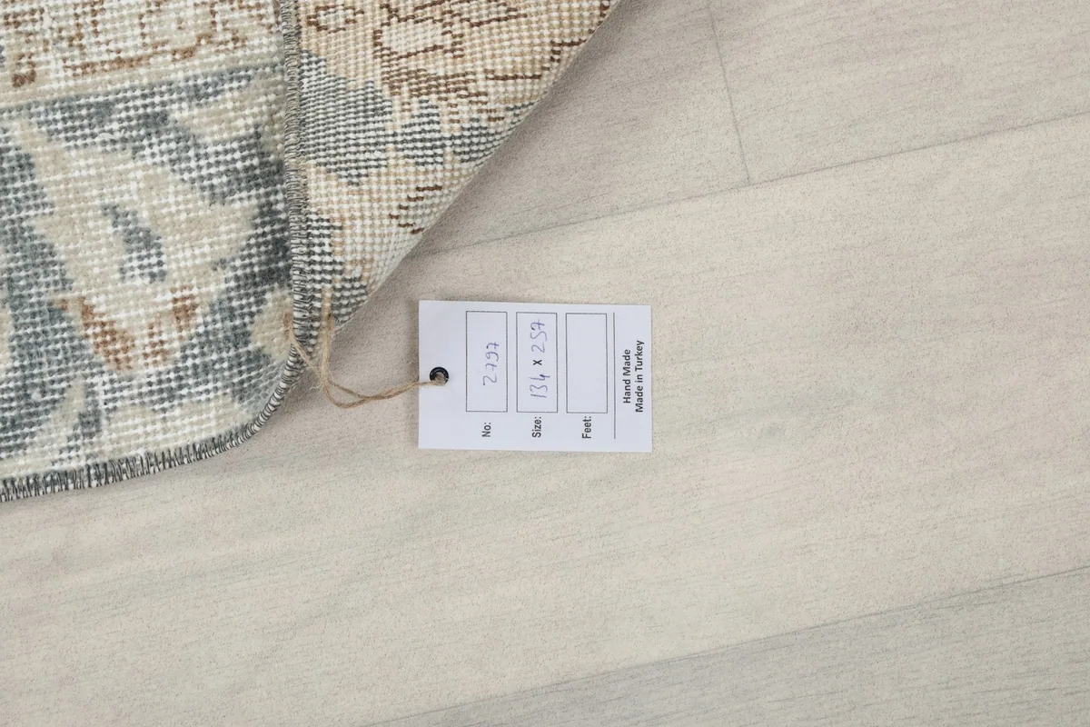 Product tag attached to the rug, confirming its hand-knotted origin from Anatolia, Turkey.