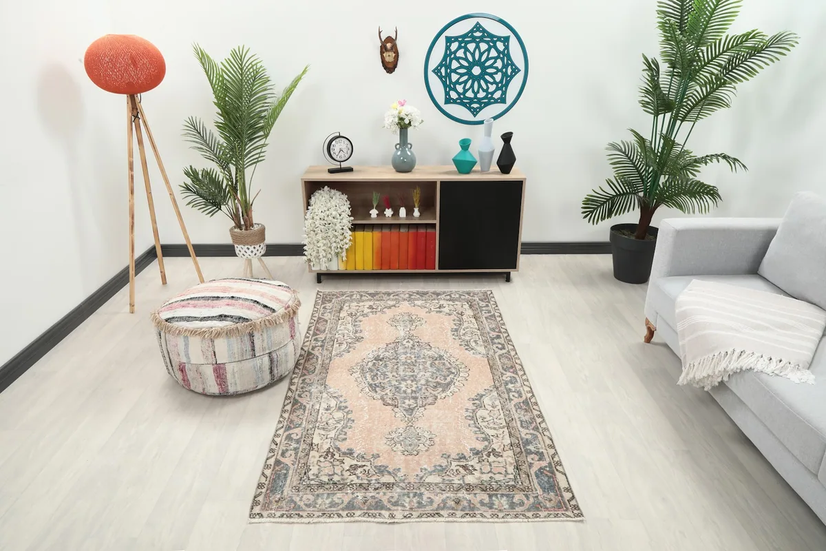 Vintage Anatolian rug in a modern living room setting with a light gray sofa and wooden cabinet