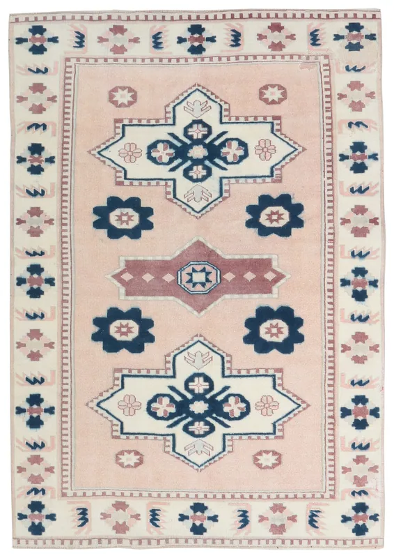 Full top view of the 5x7 rose and navy tribal Anatolian rug on a white background