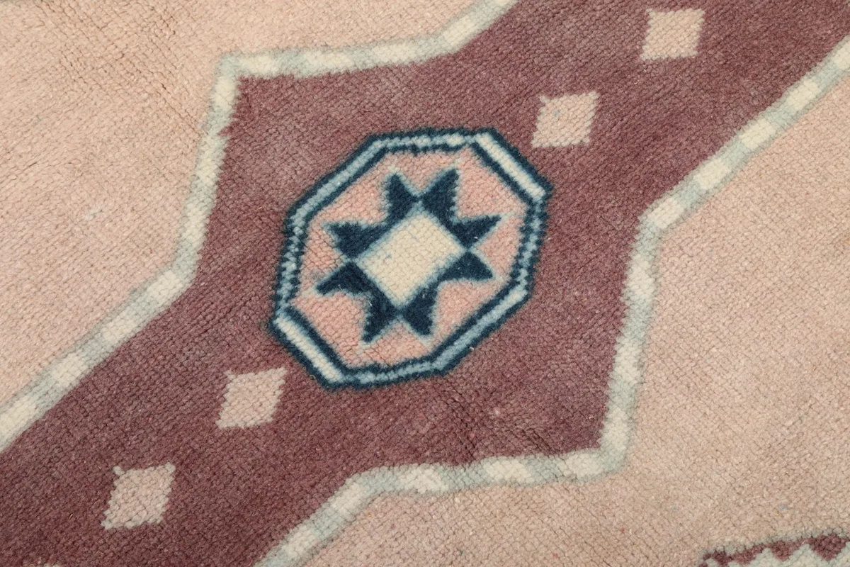 Extreme close-up of a rust-colored geometric element with navy and ivory details