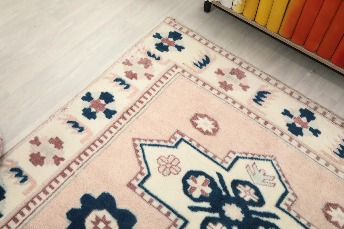 Close-up of the rug's border and a corner, revealing the intricate geometric patterns