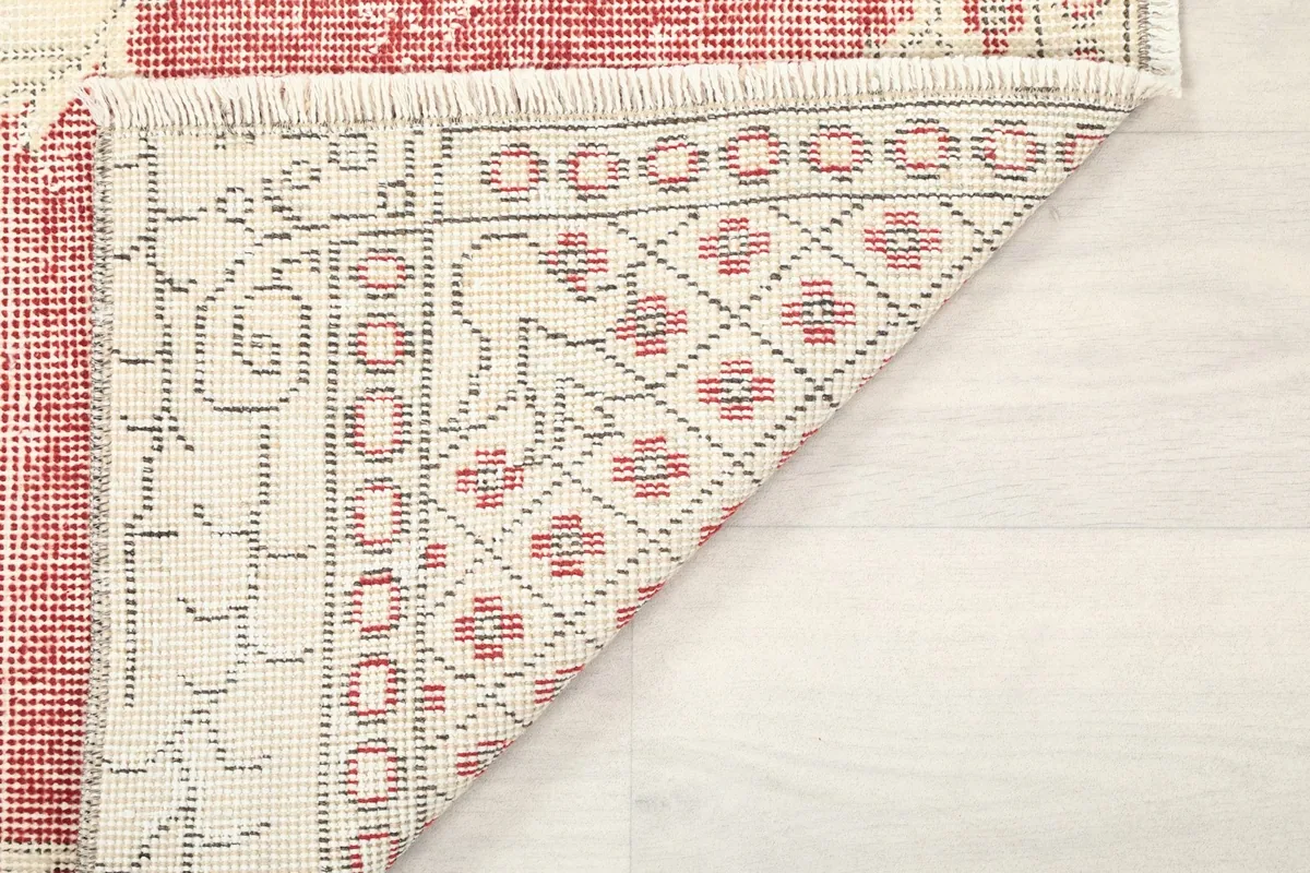 Underside view of the rug, showing the hand-knotted cotton foundation