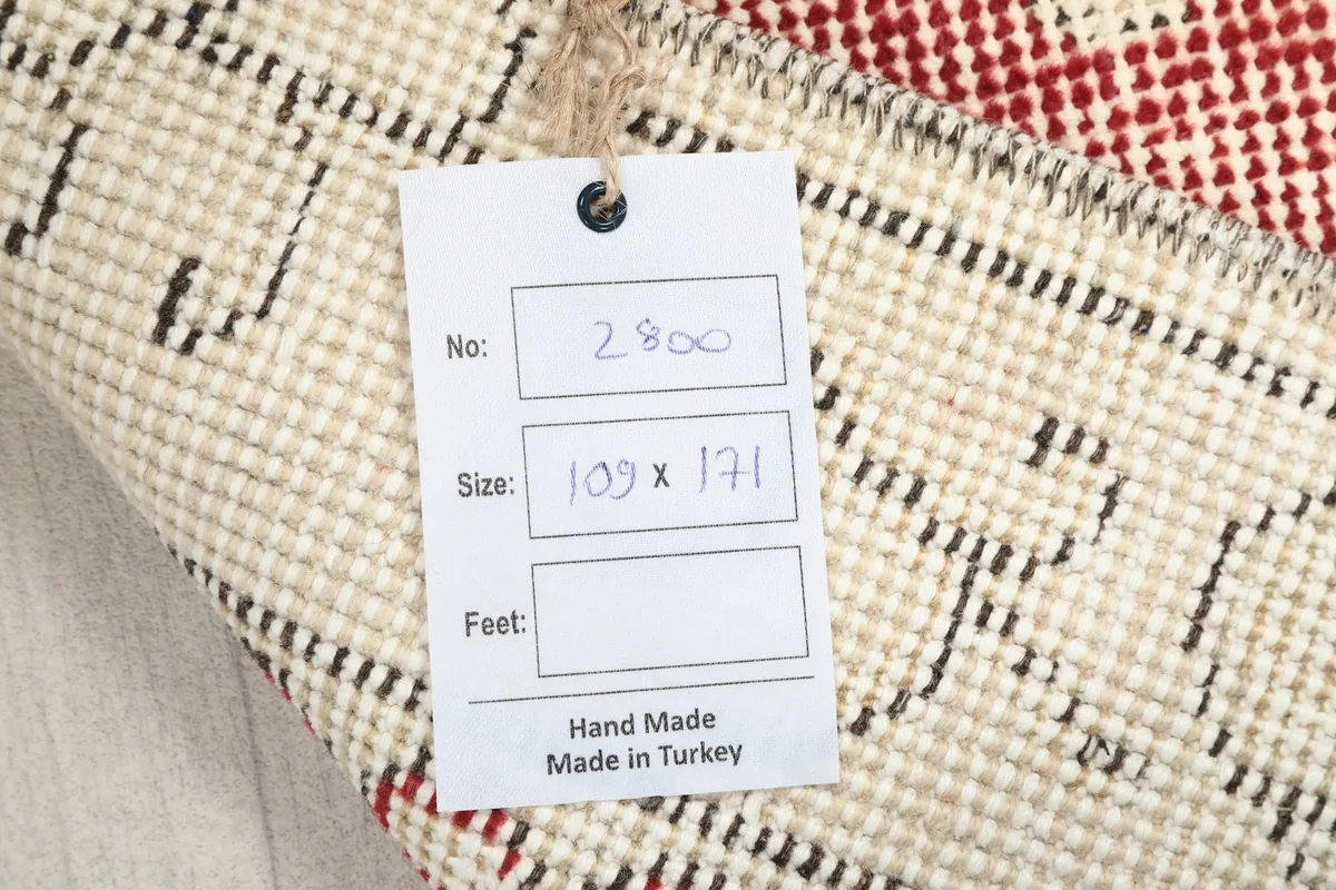 Tag on the back of the rug indicating its size and handmade origin from Turkey
