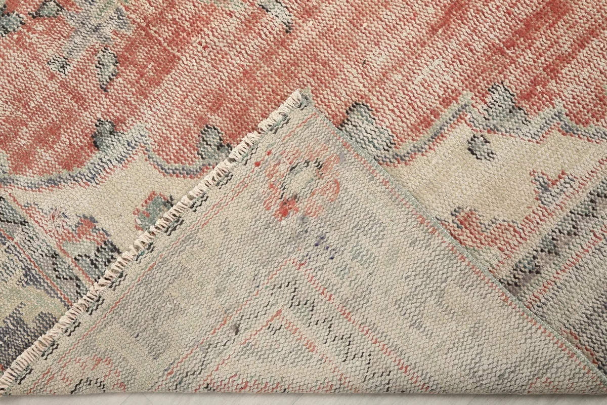 View of the back of the hand-knotted wool rug, showing a folded corner