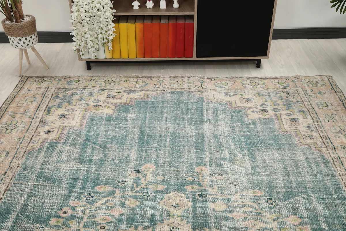 Overhead view of the rug's blue field and decorative elements in a room