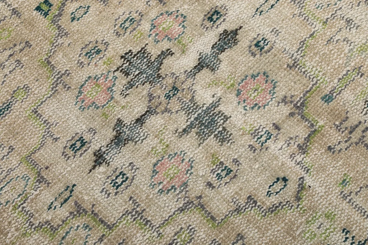 Macro view of the hand-knotted wool pile and subtle color variations