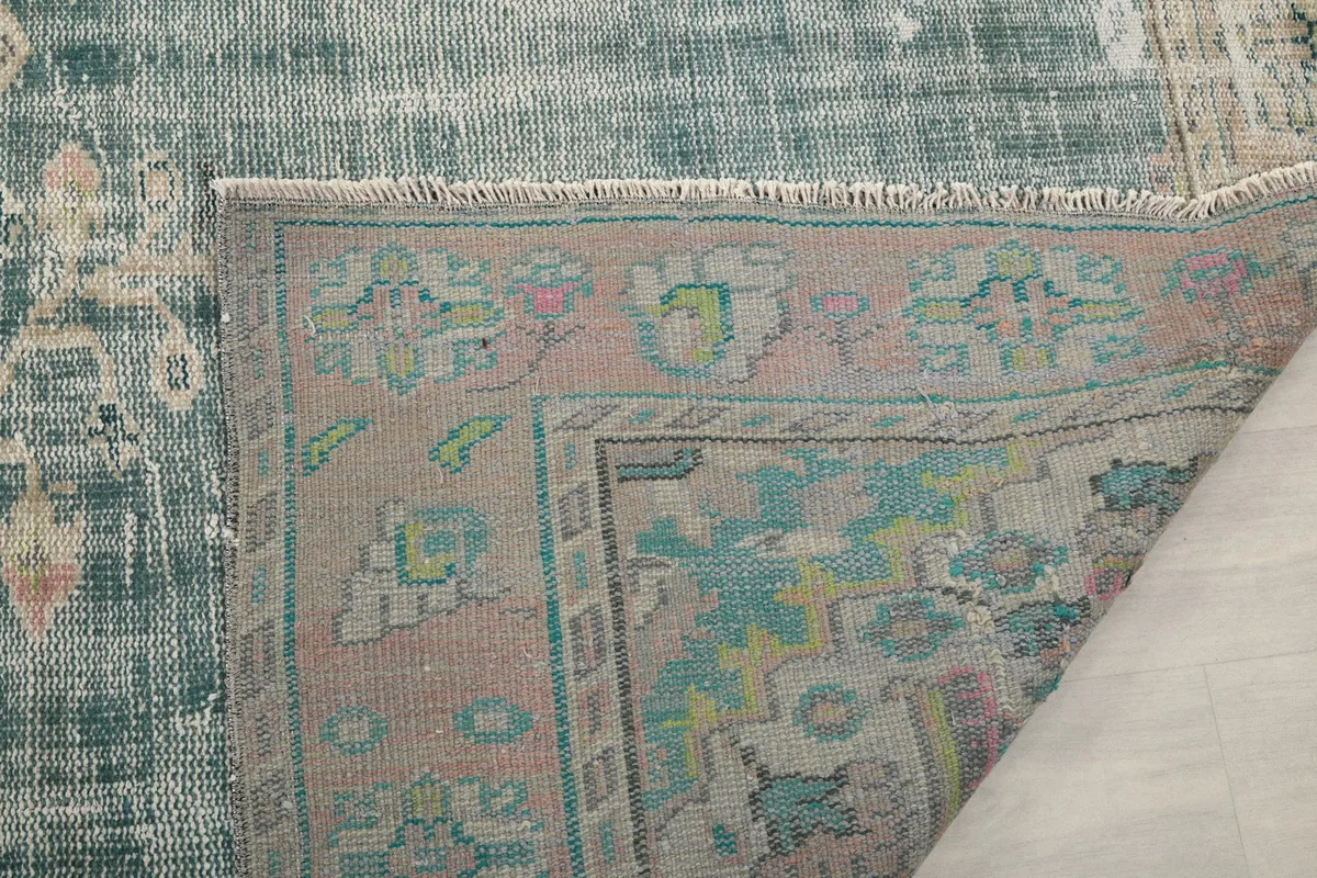 Close-up of the rug's back, revealing the cotton foundation and knotting