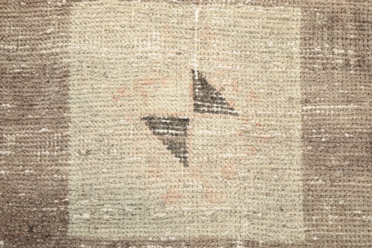 Very close detail of the central gray and black elements within a geometric motif