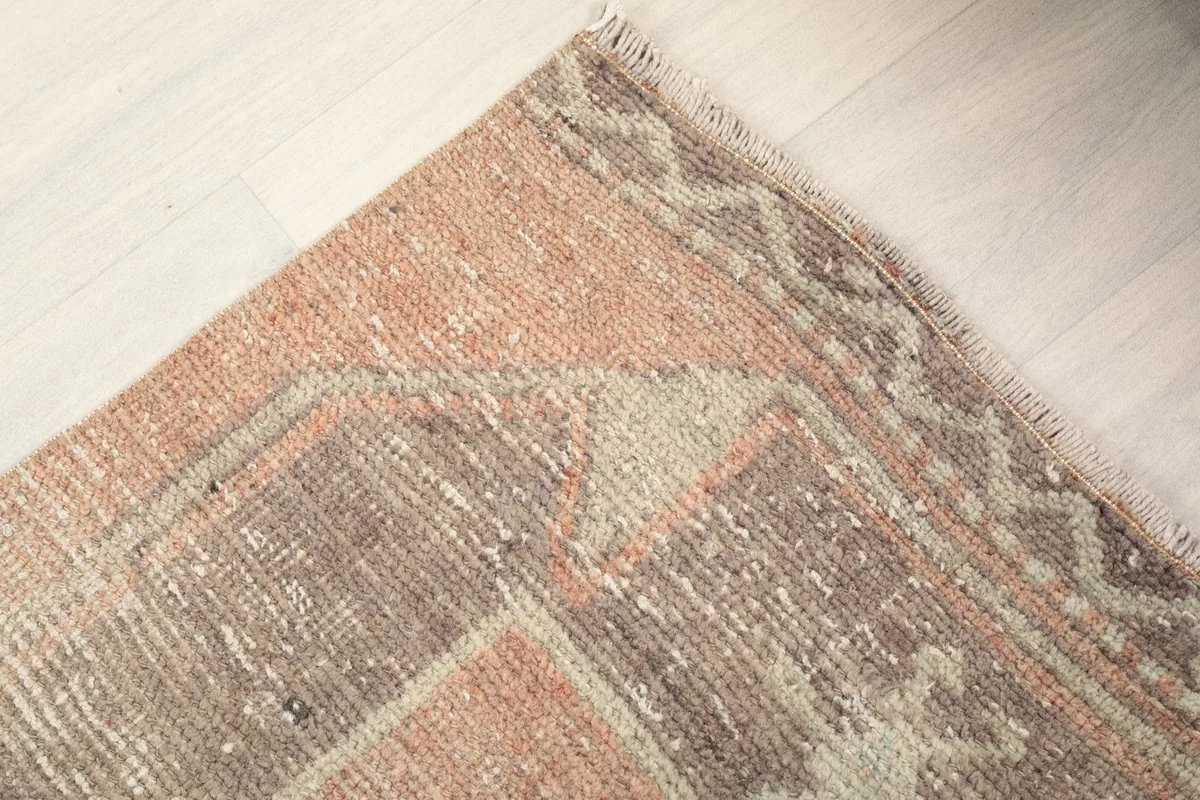Close-up of the subtle geometric border pattern and edge of the Anatolian rug