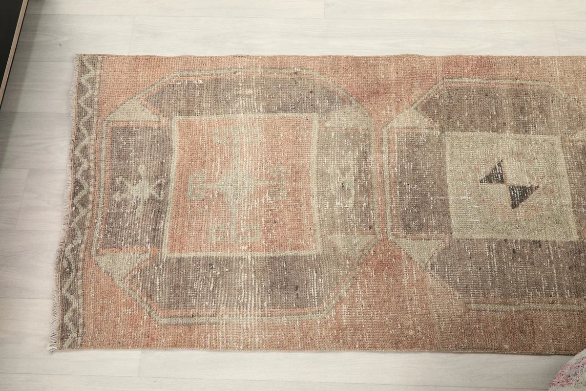 Overhead shot showing a section of the rust and gray geometric runner rug