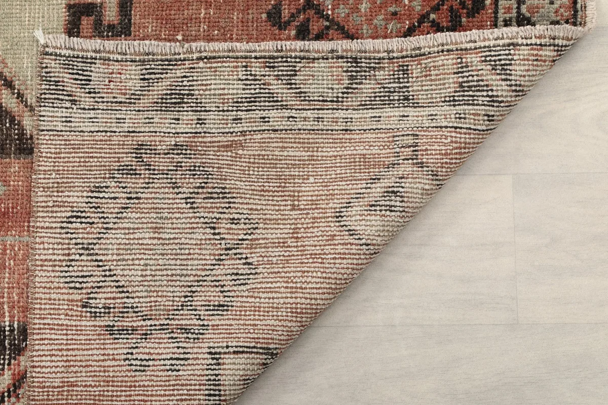 Close-up of the back of the rug, revealing the intricate hand-knotting and foundation structure