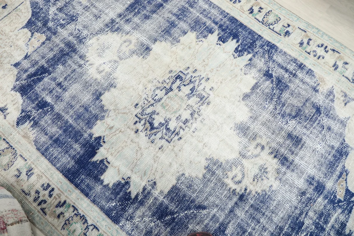 Close-up of the central medallion design and distressed texture