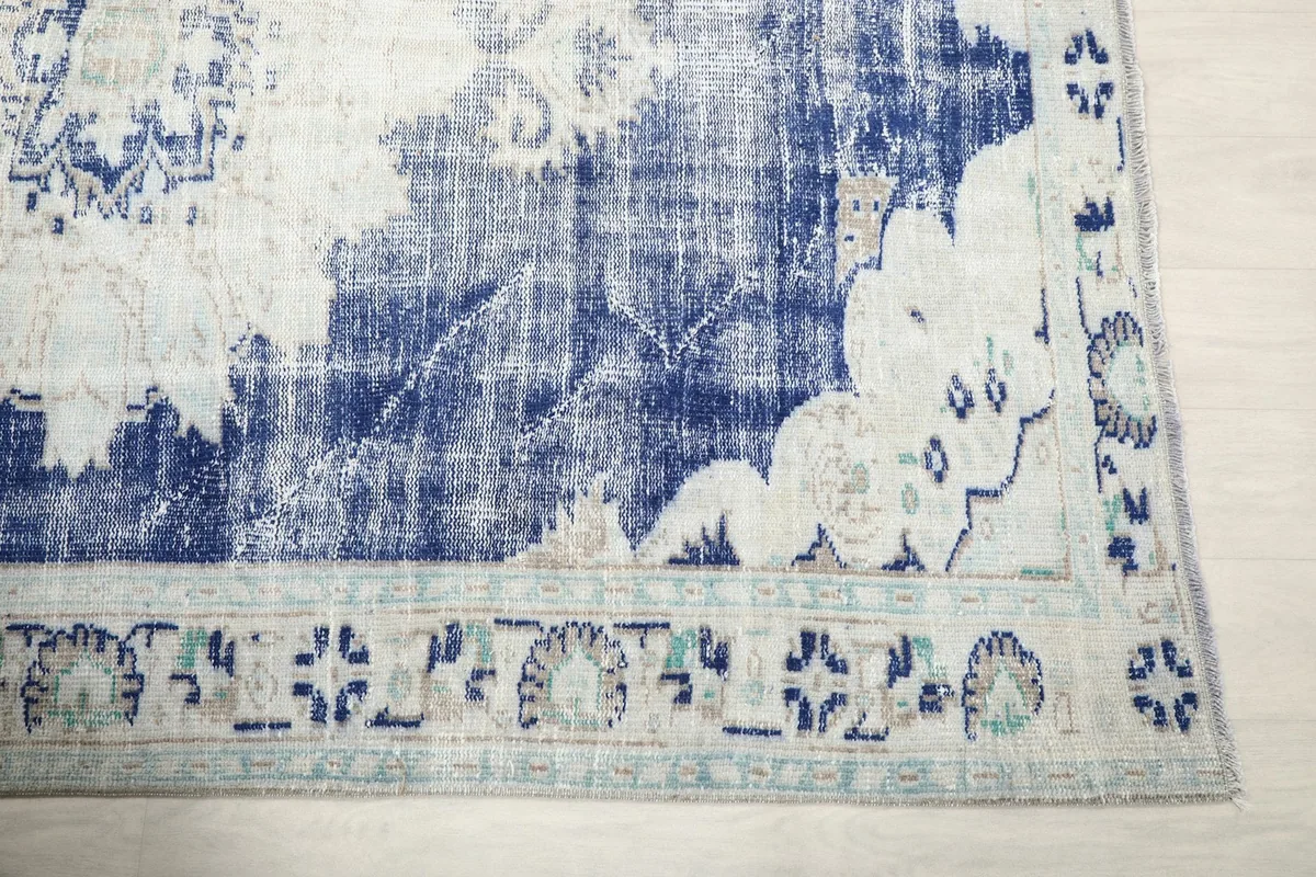 Detail of the ivory border with subtle blue and green motifs