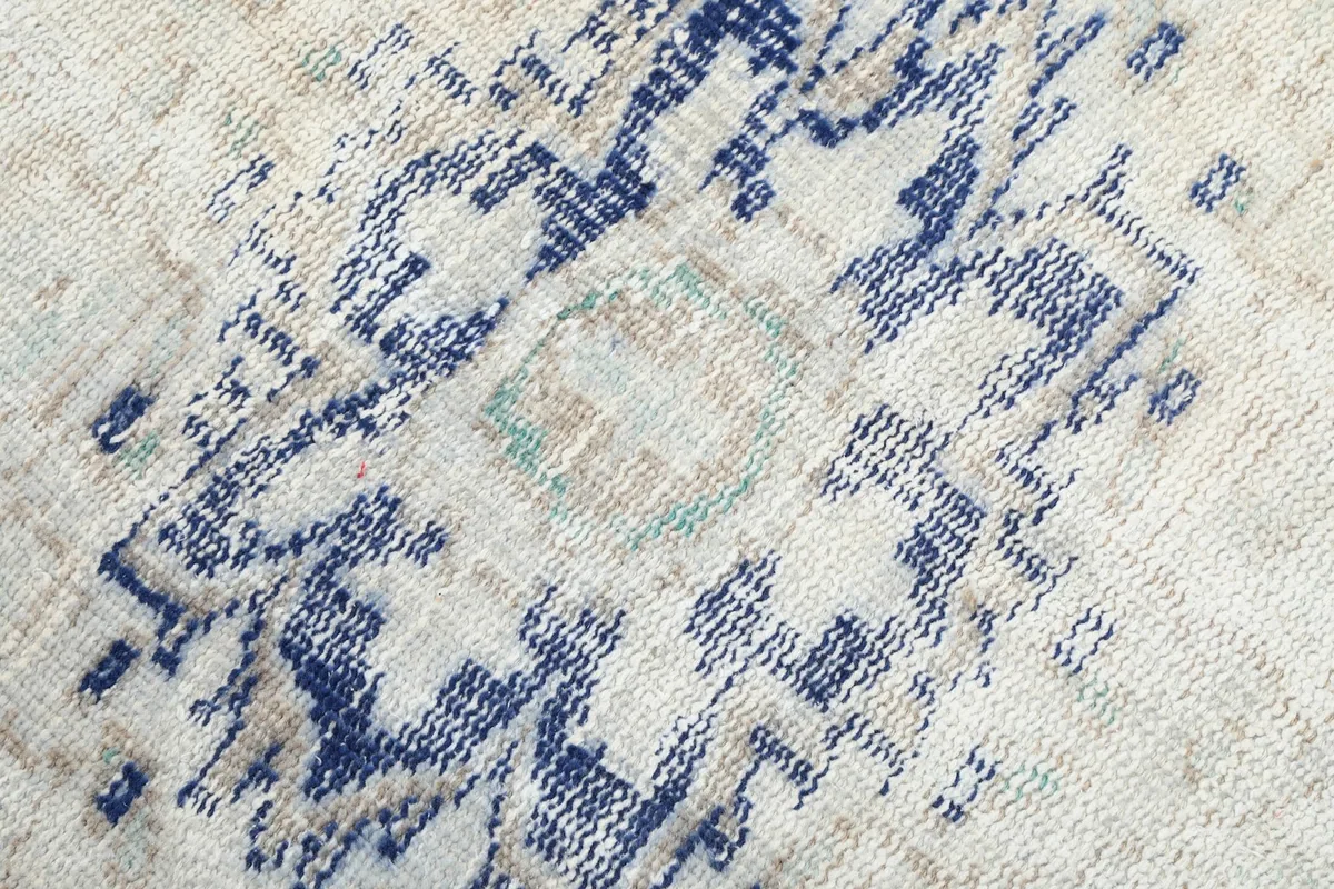 Macro view of the hand-knotted wool pile and subtle color variations