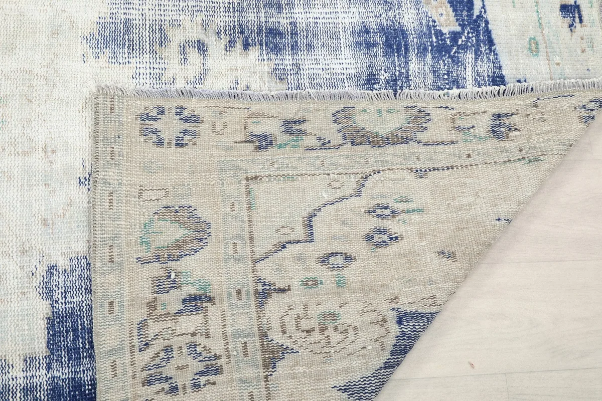 Close-up of the rug's reverse side, showing the knotting structure and foundation