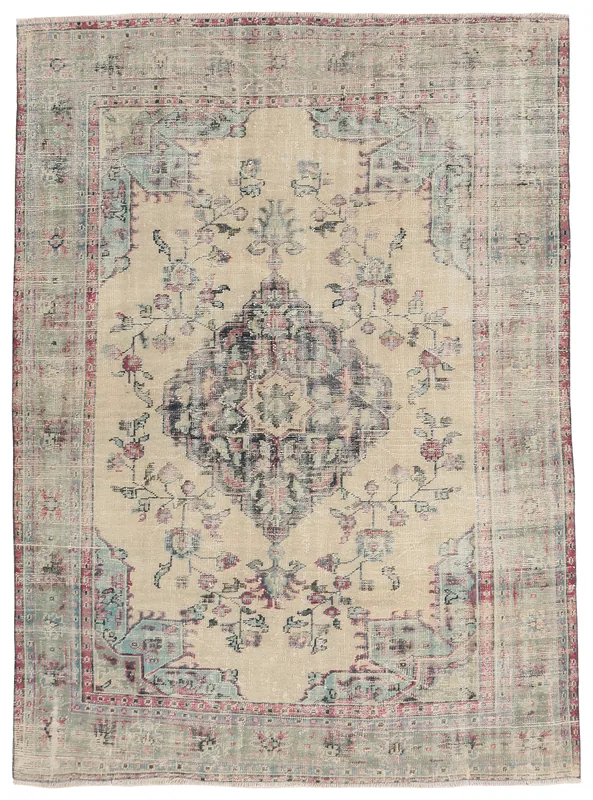 Full overhead view of the beige and navy vintage Anatolian rug on a white background.