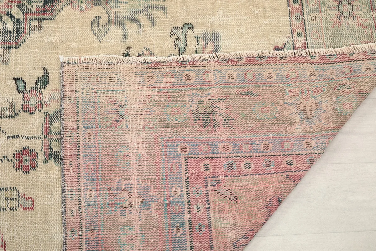 Close-up of the back of the rug, showcasing the detailed knotting and natural fringed edge.