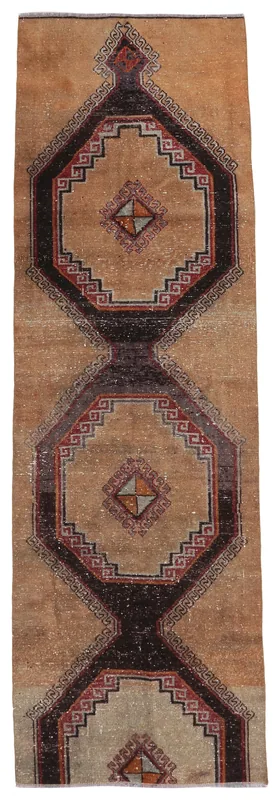Full overhead view of the tan geometric tribal runner rug on a white background.
