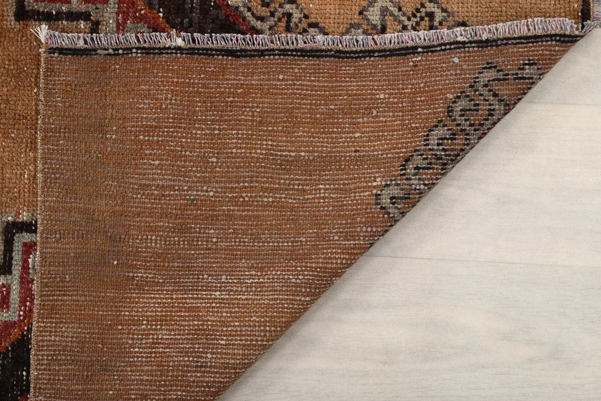 Another view of the rug's reverse side, revealing the dense knotting and material.