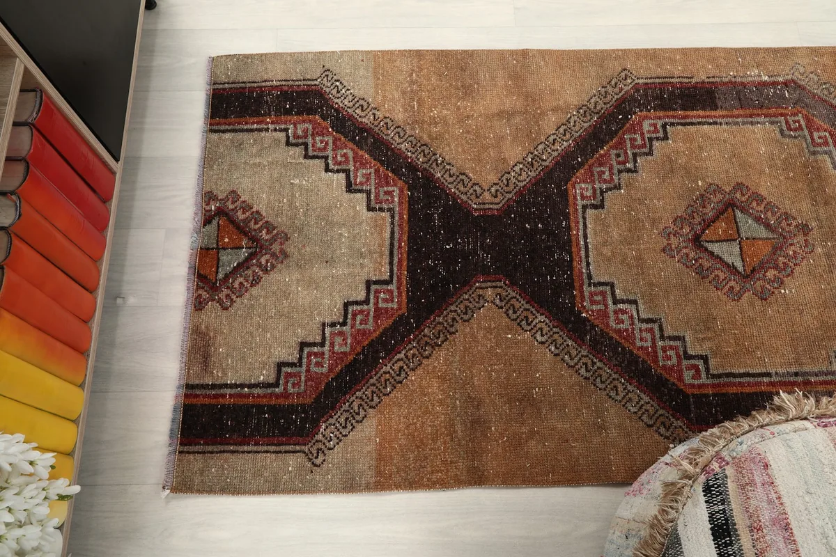 Overhead view of the rug's middle section, showcasing the repeated geometric motifs.