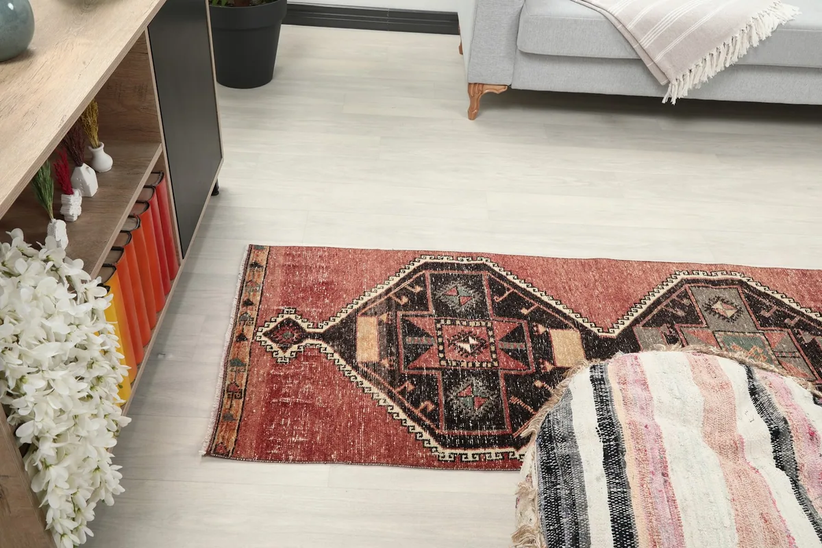 Runner rug extending from a console table towards a sofa, showing its length