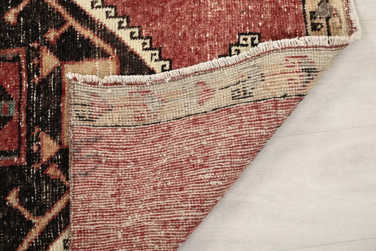 View of the underside of the hand-knotted rug, showing the knotting and foundation