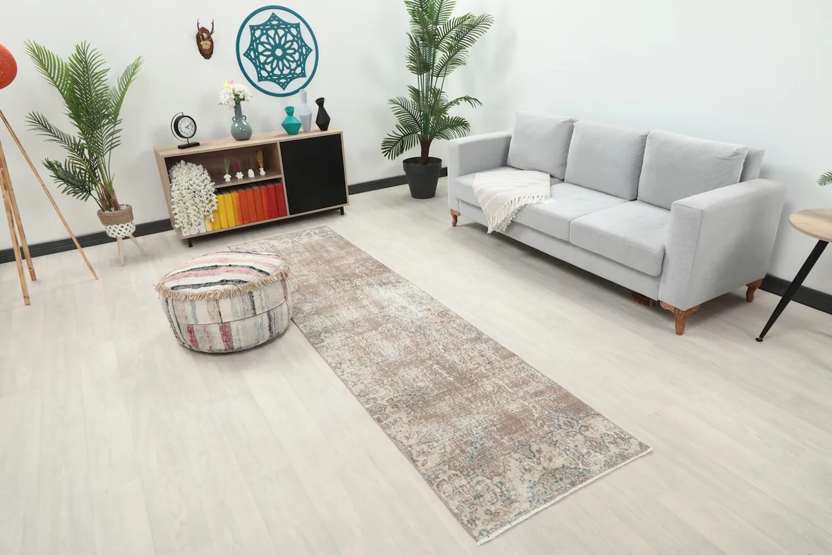 Angled view of the tan runner rug extending from a seating area in a contemporary room