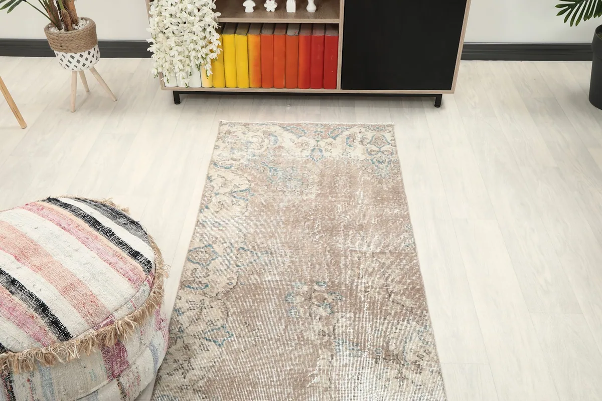 Overhead view of the tan runner rug from a higher angle in a room setting