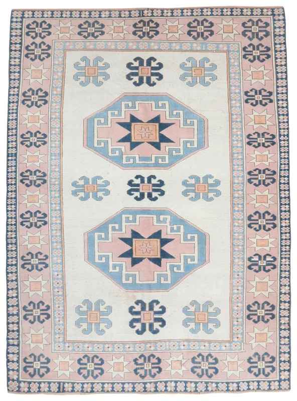 Full overhead view of the vintage ivory, pink, and navy geometric Anatolian rug.