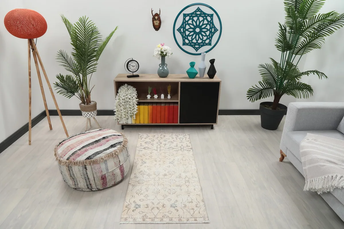 Cream area rug displayed in a modern room setting with plants and furniture