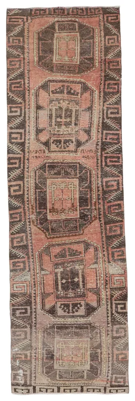 Full overhead view of a 3x10 rose and charcoal tribal runner rug on a white background