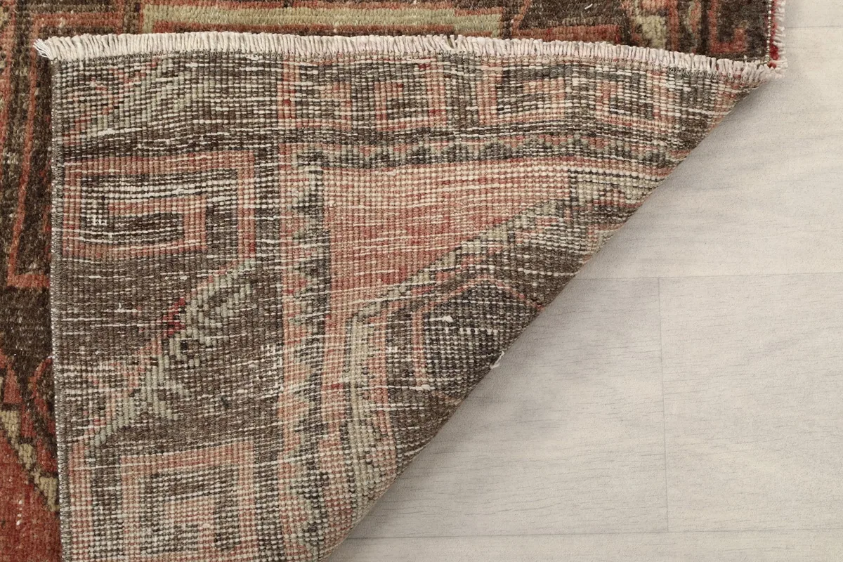 Close-up of the rug's reverse side and pile, showing the tight hand-knotting
