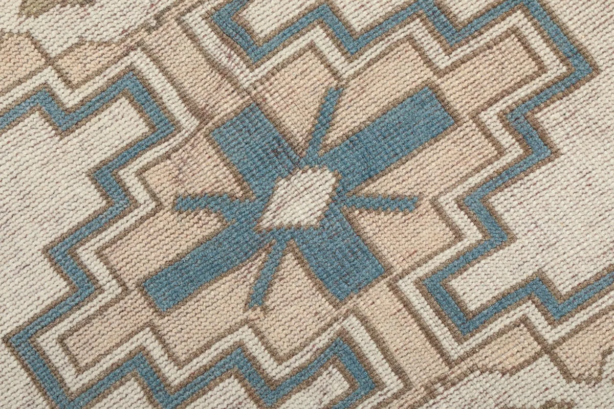 Close-up of the intricate hand-knotted details within the rug's central design