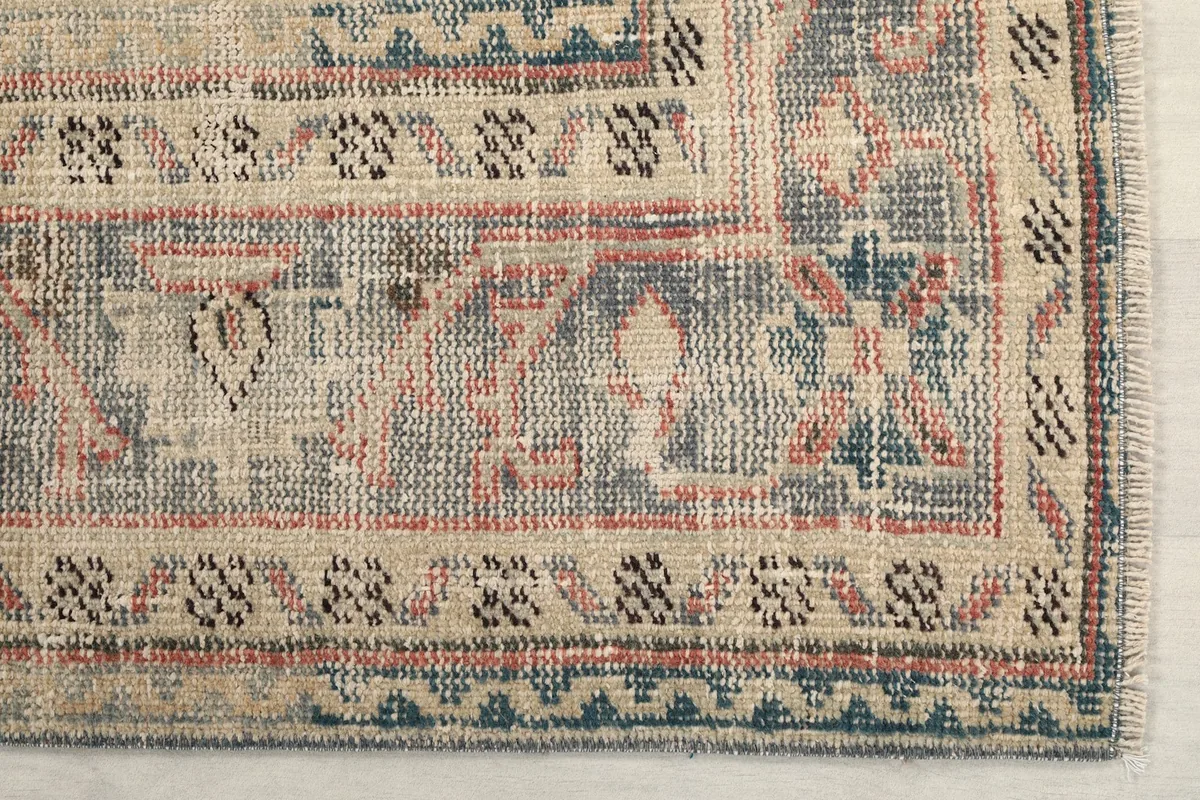 Close-up of the geometric patterns and colors in the rug's border