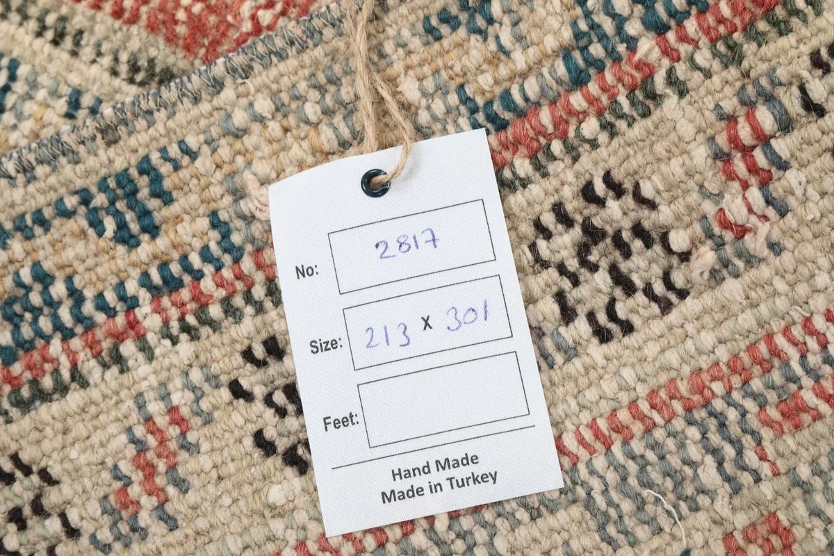 Back of the rug with a tag showing the rug number, size, and origin