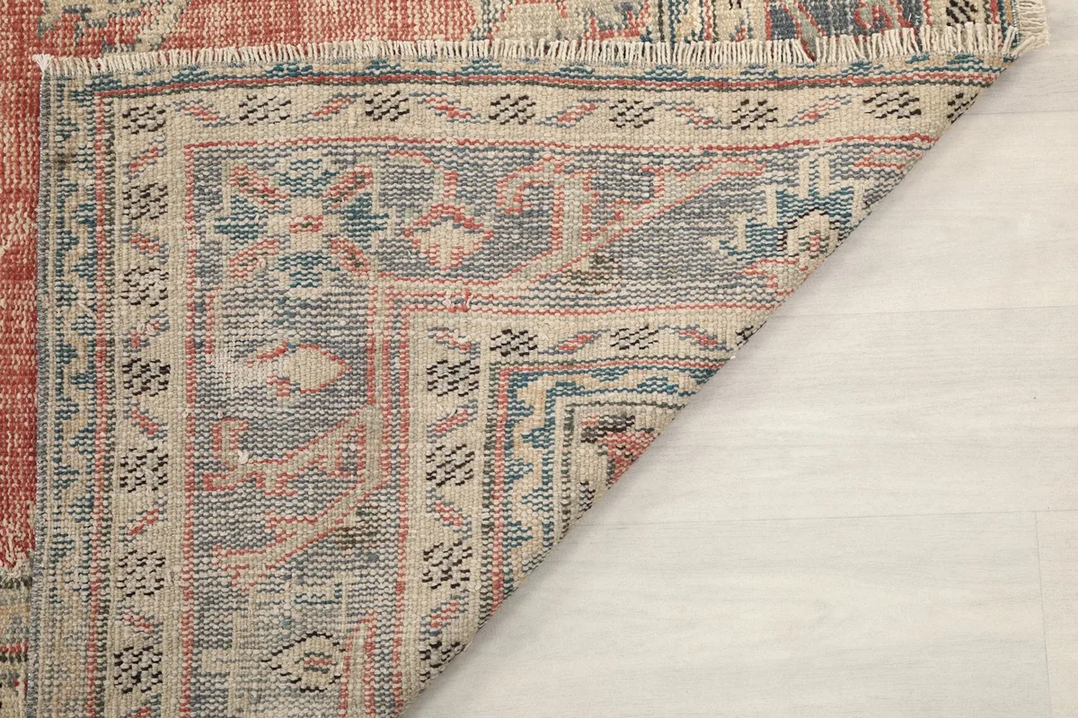 Folded corner detail showing the reverse side and hand-knotted texture