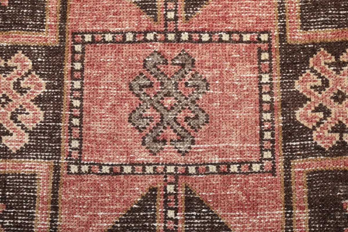 Detailed shot of a repeating motif within the rug's pattern, highlighting knotting.